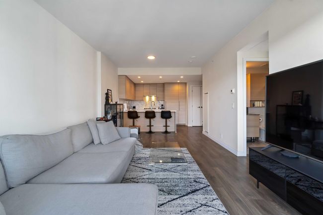 Living area with baseboards, recessed lighting, and dark wood-style flooring | Image 11