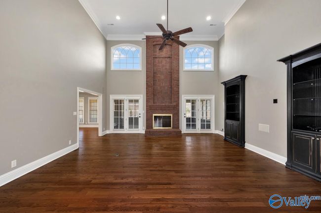 Wood flooring, built in cabinetry, fireplace, extra high ceilings, recessed lighting, crown molding | Image 4