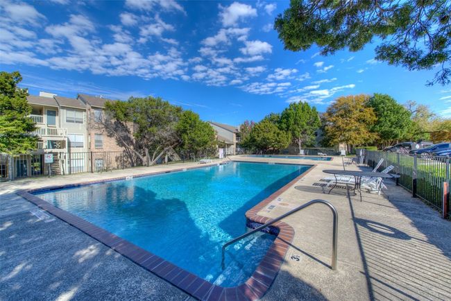 Pool with a patio area and fence | Image 22
