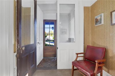 Carpeted foyer entrance featuring crown molding | Image 2