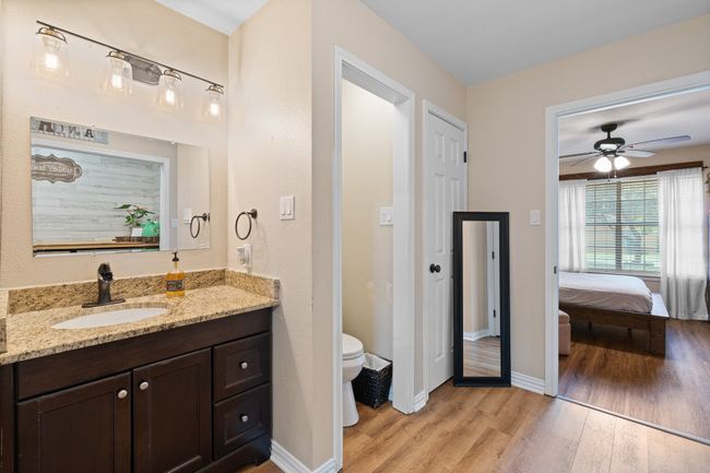 Full bath with wood finished floors, vanity, a ceiling fan, and connected bathroom | Image 17
