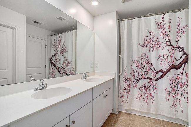 Full bath featuring double vanity, tile patterned floors, and recessed lighting | Image 26