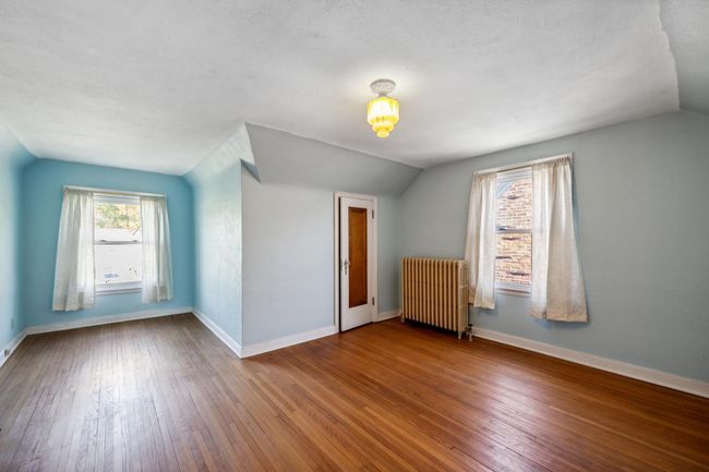 Bedroom has a nice little sitting area by the window. | Image 18