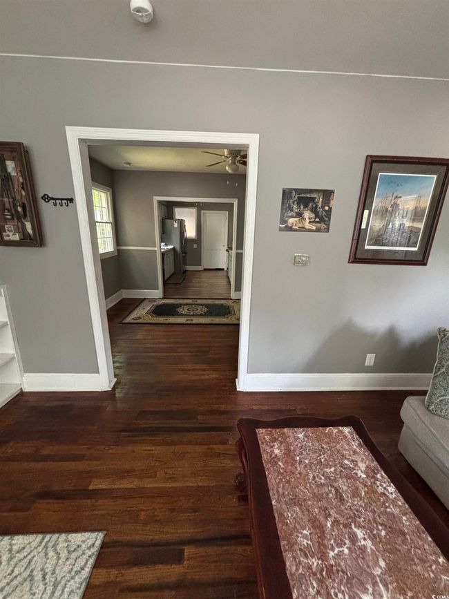 Corridor featuring baseboards and wood finished floors | Image 13
