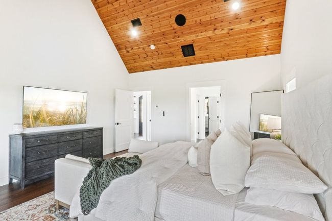 Bedroom featuring high vaulted ceiling, wooden ceiling, and wood finished floors | Image 22