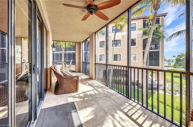 Unfurnished sunroom featuring a ceiling fan and a water view | Image 31
