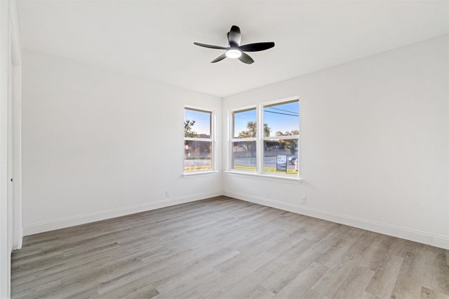 Empty room with light hardwood / wood-style flooring and ceiling fan | Image 22