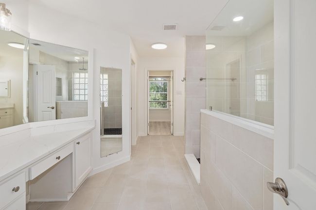 Full bath featuring walk-in shower with rainfall feature and shower wand. Double vanity quartz countertops | Image 20