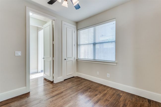 Empty room featuring wood finished floors and ceiling fan | Image 4