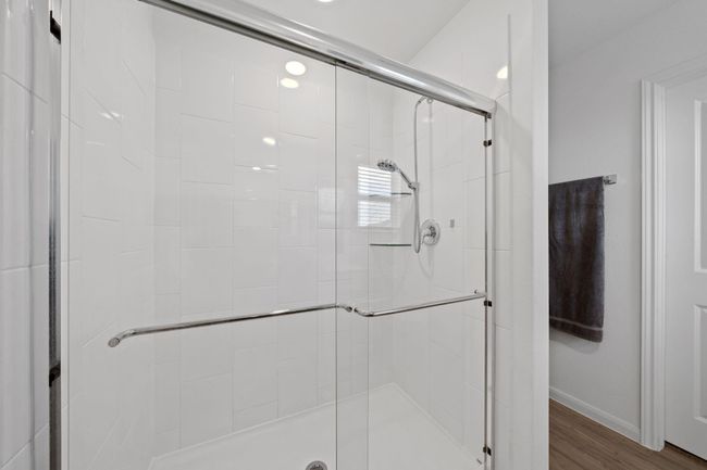 Enjoy the sleek walk-in shower and a spacious closet perfect for organized living | Image 28