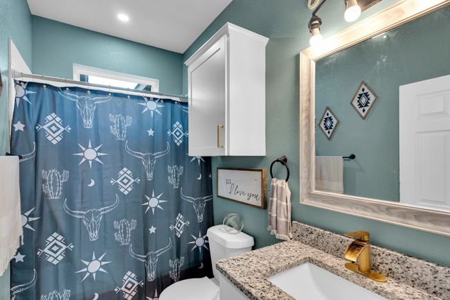Full bath featuring vanity, toilet, and curtained shower | Image 16