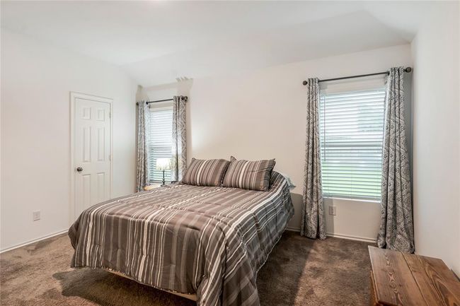 Another view of the primary bedroom, with soft lighting and plenty of room for a king-sized bed. | Image 12