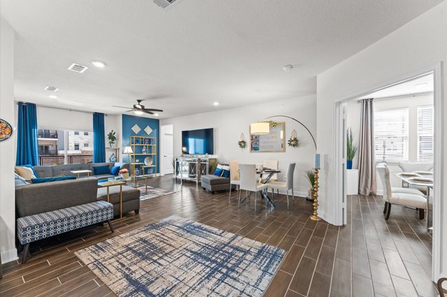 Beautifully designed open-concept living and dining area with abundant natural light and seamless flow into the adjacent flex room. | Image 6