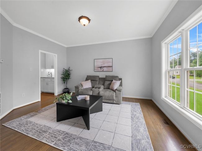 Living room featuring plenty of natural light, molding, and wood finished floors | Image 12