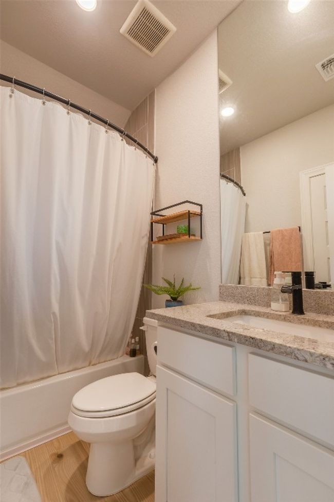 Full bathroom featuring vanity, shower / bath combination with curtain, and recessed lighting | Image 23