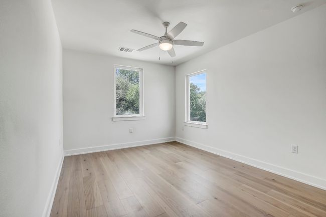 Unfurnished room with baseboards, a smoke detector, ceiling fan, and light wood-style flooring | Image 19