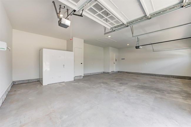 Large 3-car garage with an above ground storm shelter. | Image 28