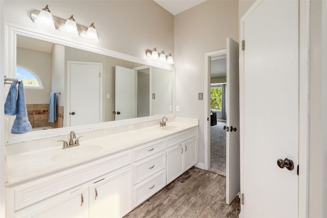 Bathroom featuring double vanity, a sink, and wood finished floors | Image 16