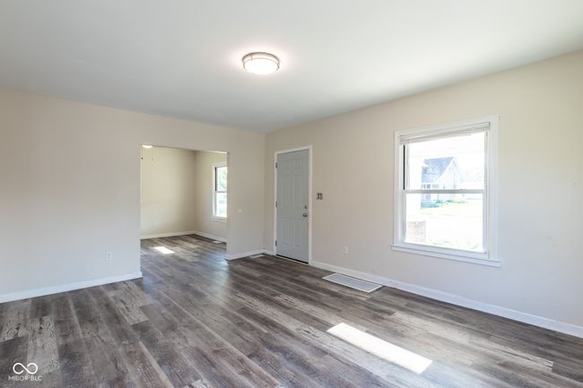 empty room with baseboards and dark wood-style flooring | Image 24