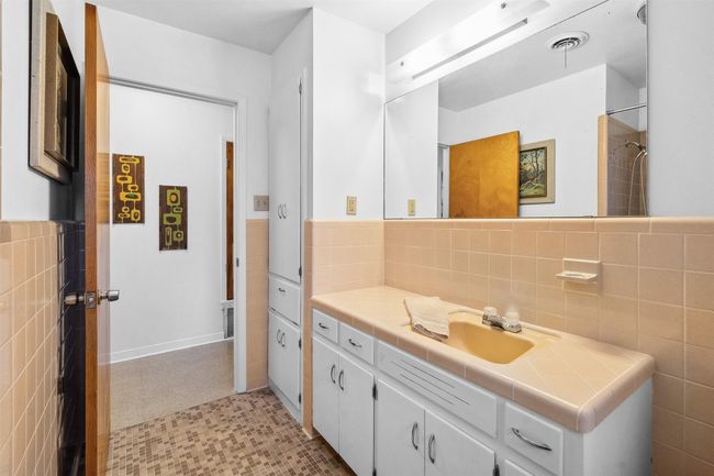 Full bath with tile patterned floors, vanity, and tile walls | Image 27