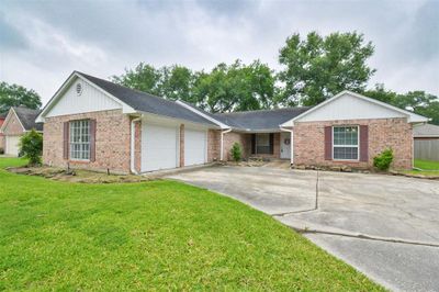 Welcome to a charming home with an inviting entrance and a spacious, attached two-car garage. | Image 2