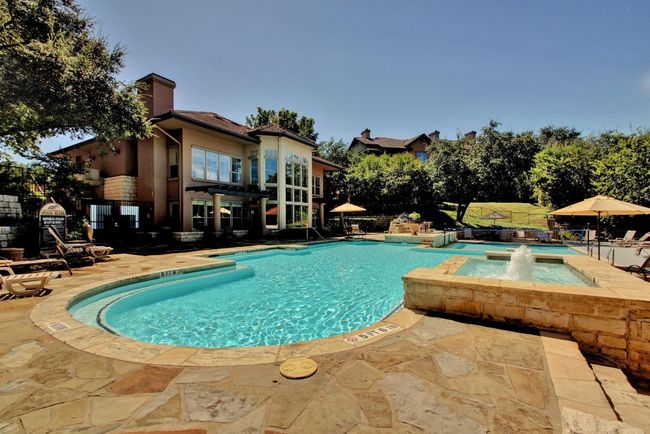 View of pool with a patio, a pergola, and a pool with connected hot tub | Image 26