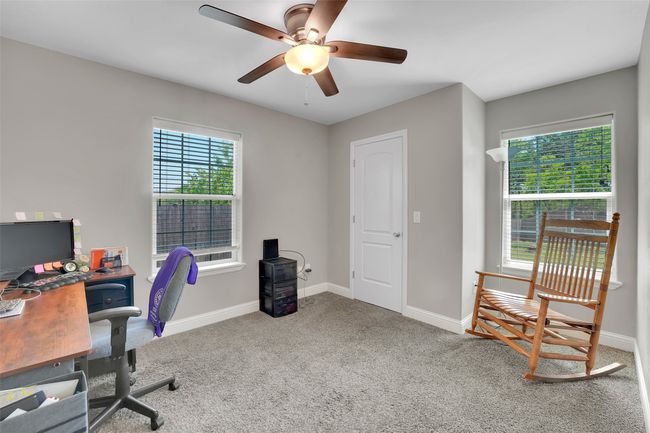 Carpeted home office featuring ceiling fan and baseboards | Image 25