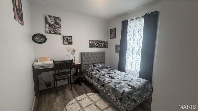 Bedroom featuring wood finished floors and baseboards | Image 8