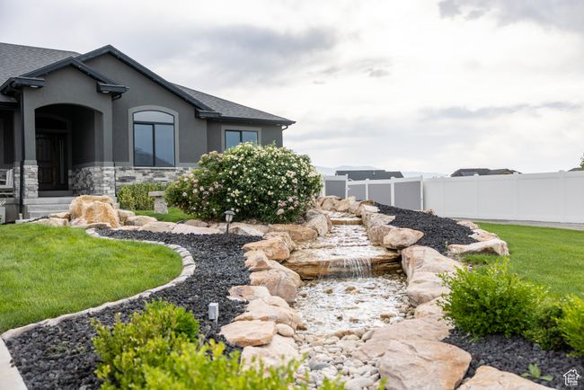 View of yard featuring a small pond | Image 5