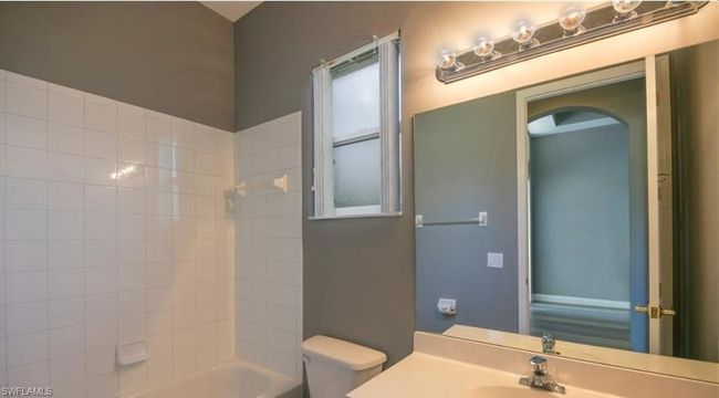 Full bathroom with tiled shower / bath combo, vanity, and toilet | Image 13