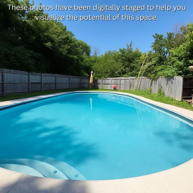 View of pool with a fenced backyard and view of scattered trees | Image 29