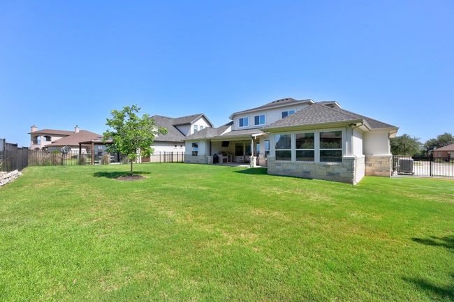 The property spans 0.41 acres, offering a generous backyard. It features wrought iron perimeter fencing and a stone retaining wall, which enhance the structural beauty of the space. | Image 40