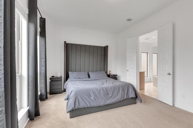 Carpeted bedroom with baseboards | Image 28