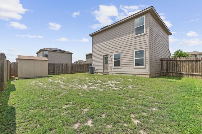 Back of property with an outdoor structure, cooling unit, a fenced backyard, a storage unit, and a lawn | Image 19