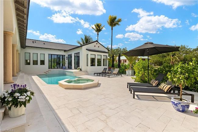 Pool with a patio area and an in ground hot tub | Image 44