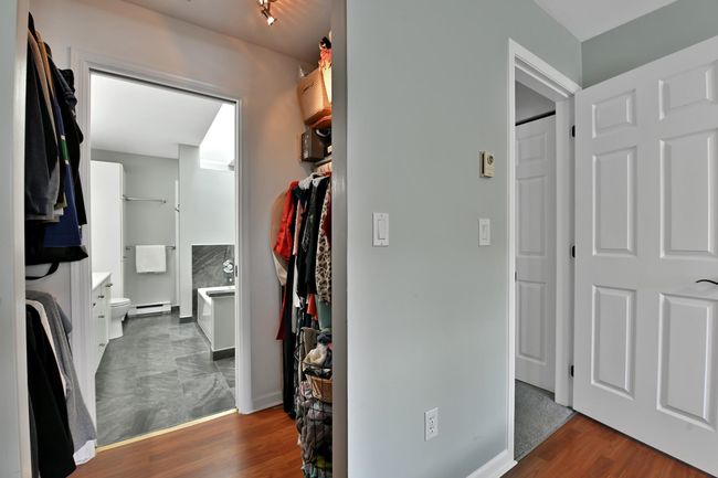 Walk in closet featuring a baseboard radiator and wood finished floors | Image 26