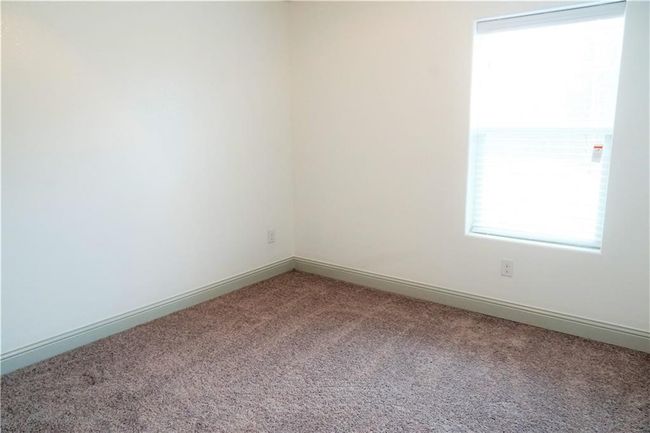 Spare room with light colored carpet and baseboards | Image 8