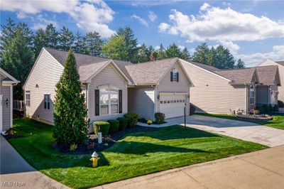 Ranch-style house with a garage and a front lawn | Image 2