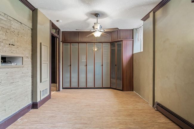Custom closet storage. The hallway to the left has access to the lower full bathroom and lower level hallway (laundry, community room, storage and workshop). | Image 24