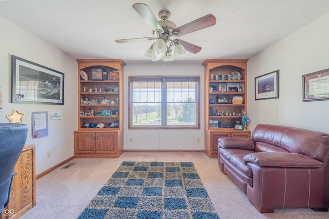 living area with baseboards, visible vents, a ceiling fan, and light colored carpet | Image 15