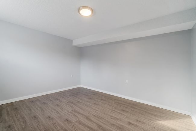 Spare room featuring baseboards and wood finished floors | Image 33