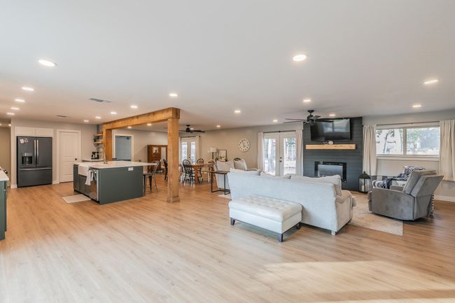 Living room with ceiling fan, recessed lighting, french doors, light wood-style flooring, and a fireplace | Image 8