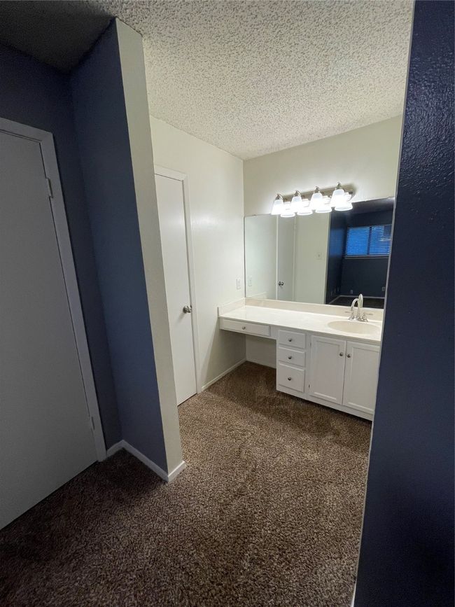 Bathroom featuring a textured ceiling and vanity | Image 18