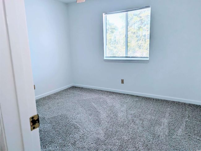 Carpeted spare room with baseboards | Image 8