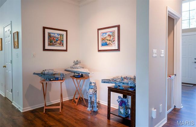 Corridor with wood finished floors and crown molding | Image 16