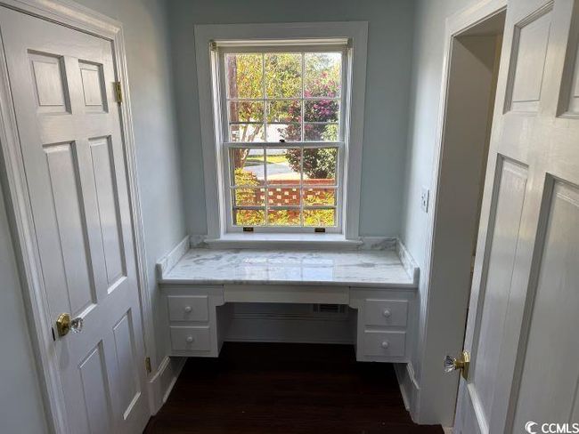 Unfurnished office with built in desk and dark hardwood / wood-style flooring | Image 17