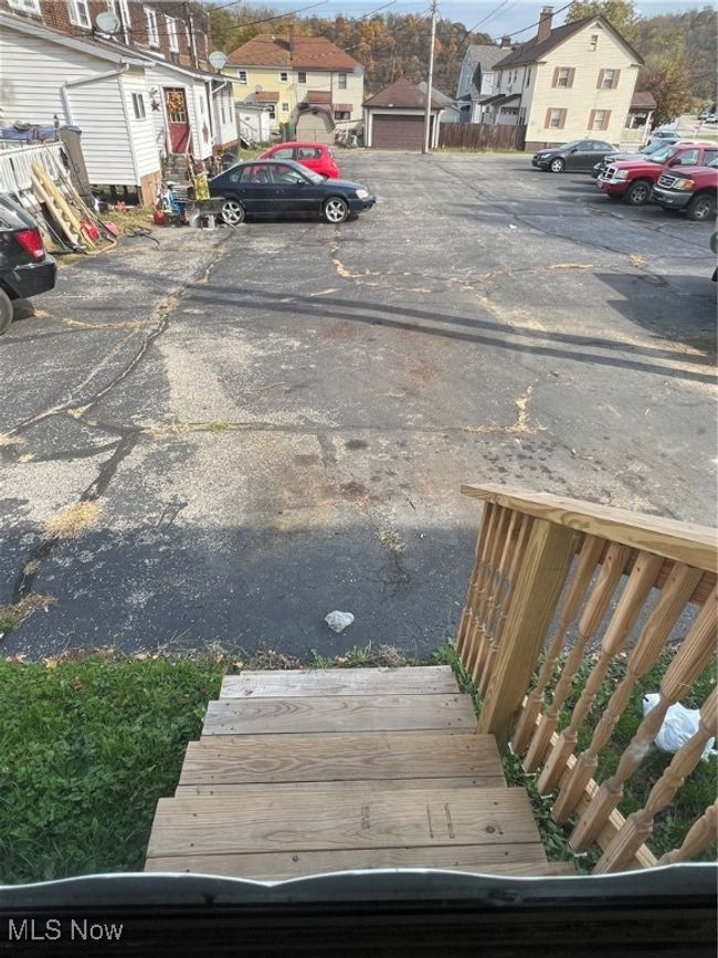 View of parking / parking lot featuring a garage | Image 6