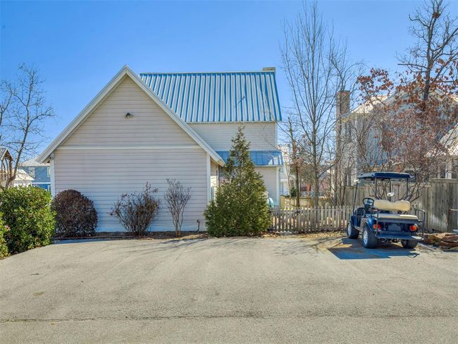 View of side of property featuring fence and metal roof | Image 33