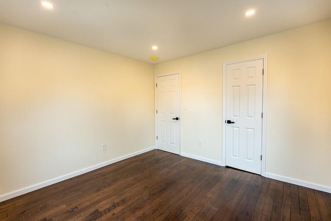 Unfurnished bedroom #1 with dark wood-style flooring, baseboards, and recessed lighting | Image 12