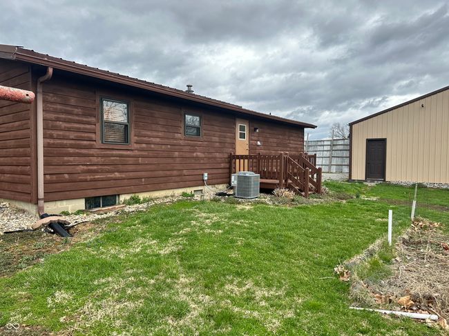 back of house with central AC unit and a yard | Image 7